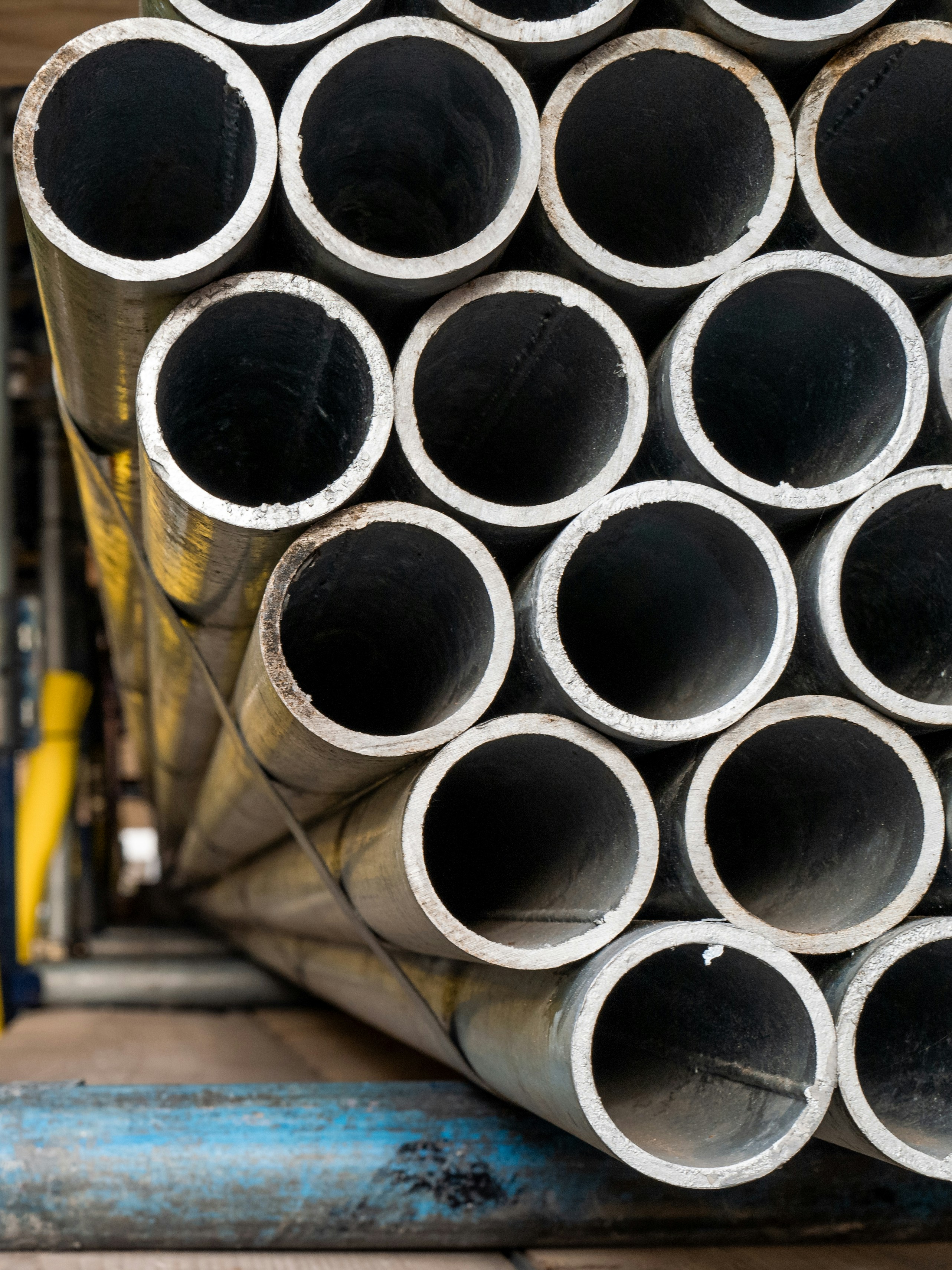 Stacked large-bore pipe ends in a yard