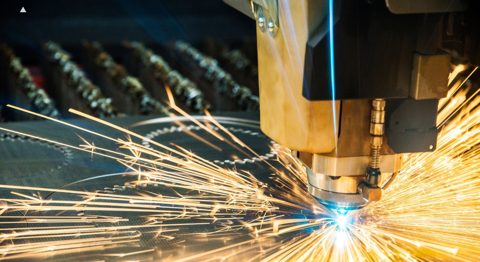 Plasma cutting sheet metal in a fabrication shop.