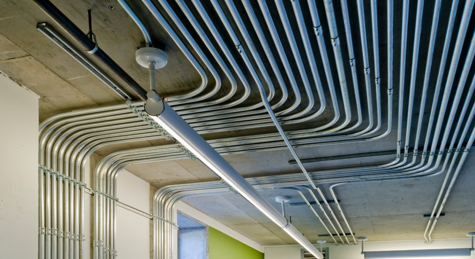 Electrical prefab racks and conduit assemblies staged in the shop.