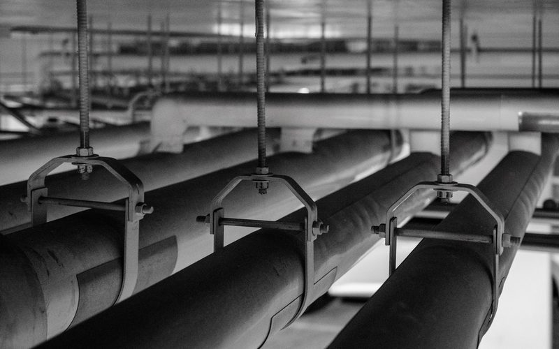 Pipe mains on hangers overhead