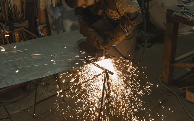 Fabricator cutting sheet metal