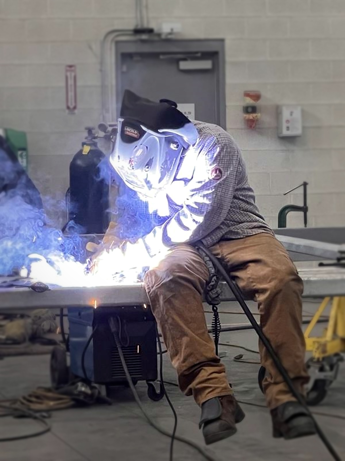 Welder at work in a fabrication shop